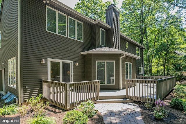 9 Sleepy Hollow Ln, West Windsor, NJ 08550 - rear view of property featuring a wooden deck and a chimney