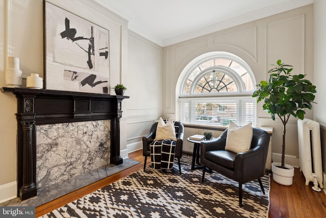 238 S 13th St Unit 1, Philadelphia, PA 19107 - sitting room featuring wood finished floors, radiator, ornamental molding, and a decorative wall