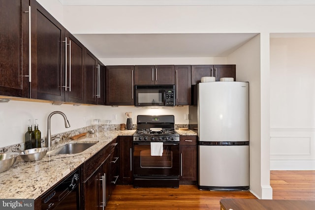 238 S 13th St Unit 1, Philadelphia, PA 19107 - kitchen featuring black appliances, dark wood-style flooring, light stone countertops, and dark brown cabinets