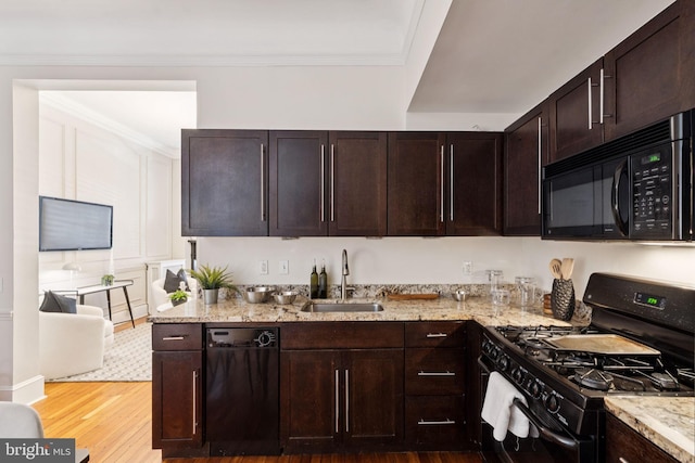 238 S 13th St Unit 1, Philadelphia, PA 19107 - kitchen with black appliances, light stone counters, wood finished floors, and crown molding