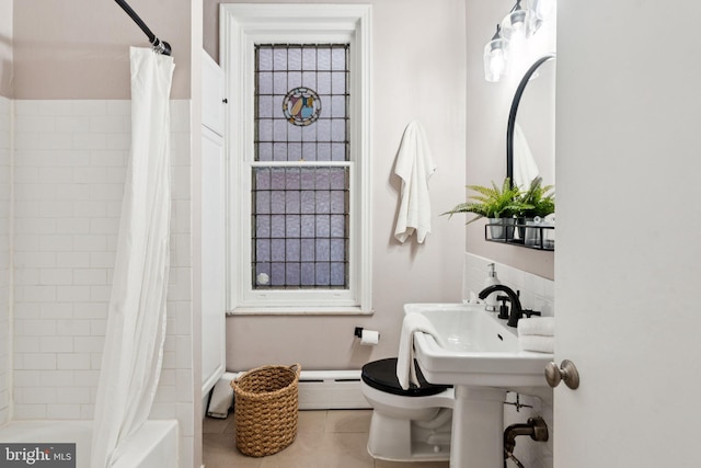 238 S 13th St Unit 1, Philadelphia, PA 19107 - bathroom featuring a baseboard radiator, shower / bath combo with shower curtain, and tile patterned floors