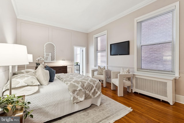 238 S 13th St Unit 1, Philadelphia, PA 19107 - bedroom featuring radiator, crown molding, and wood finished floors