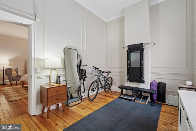 238 S 13th St Unit 1, Philadelphia, PA 19107 - workout area featuring a decorative wall, light wood-style flooring, and ornamental molding