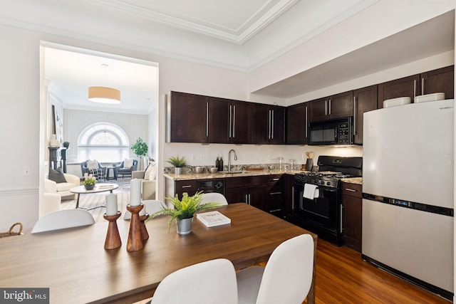 238 S 13th St Unit 1, Philadelphia, PA 19107 - kitchen featuring black appliances, dark brown cabinetry, dark wood-style flooring, crown molding, and light stone countertops