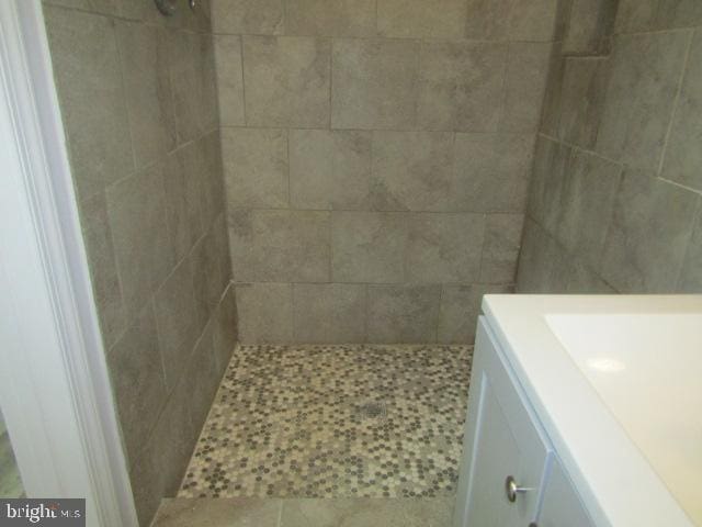 1303 N Patterson Park Ave, Baltimore, MD 21213 - bathroom with a tile shower, vanity, and tile patterned flooring