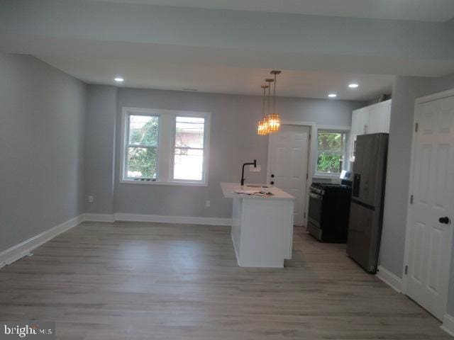 1303 N Patterson Park Ave, Baltimore, MD 21213 - kitchen with stainless steel appliances, light wood-style flooring, plenty of natural light, and recessed lighting