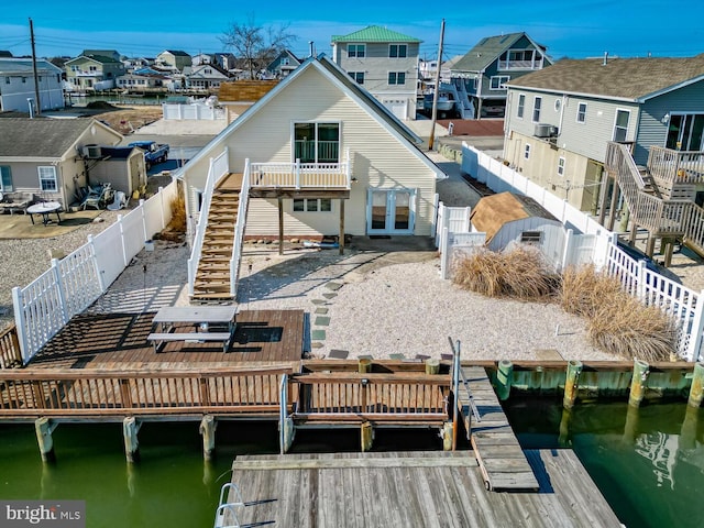 119 S Captains Dr, Little Egg Harbor Twp, NJ 08087 - back of house with stairway, a residential view, a fenced backyard, and a deck with water view