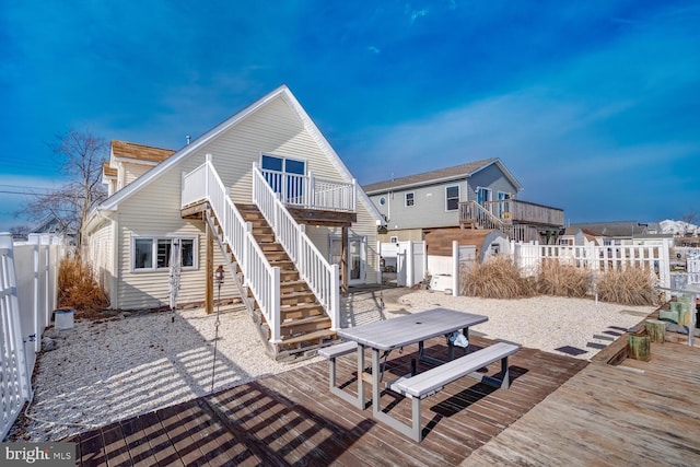 119 S Captains Dr, Little Egg Harbor Twp, NJ 08087 - rear view of property featuring stairs, a wooden deck, outdoor dining space, and a fenced backyard