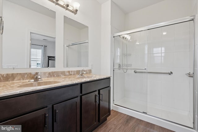 200 Harvin Way Unit 231, Brookhaven, PA 19015 - full bathroom featuring double vanity, a shower stall, and wood finished floors