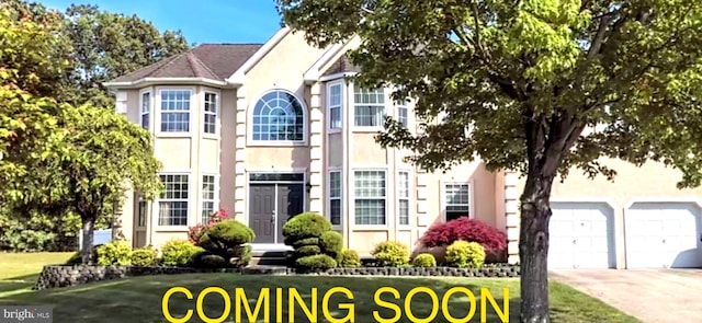 141 Blue Meadow Ln, Sicklerville, NJ 08081 - view of front facade with stucco siding, concrete driveway, and a garage
