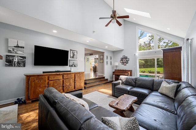 10309 E Hunter Valley Rd, Vienna, VA 22181 - living area with wood finished floors, a skylight, high vaulted ceiling, healthy amount of natural light, and ceiling fan