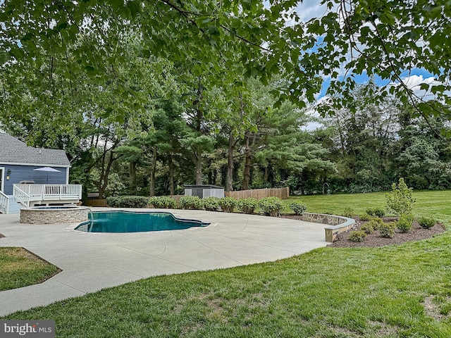10309 E Hunter Valley Rd, Vienna, VA 22181 - view of swimming pool featuring a deck, a patio area, a lawn, a pool with connected hot tub, and view of scattered trees