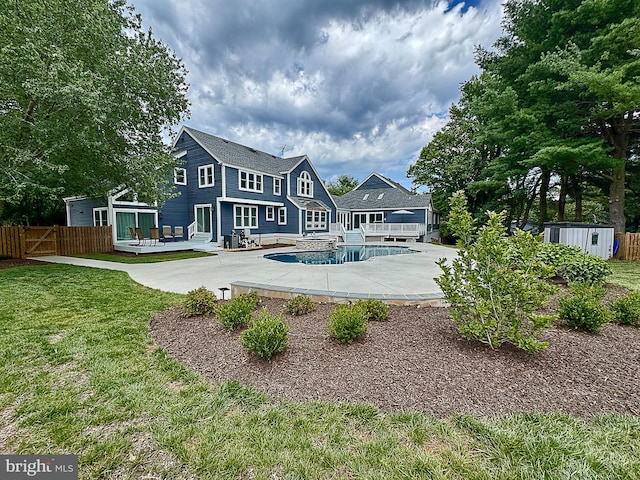 10309 E Hunter Valley Rd, Vienna, VA 22181 - rear view of property featuring a deck, a storage shed, and a patio area