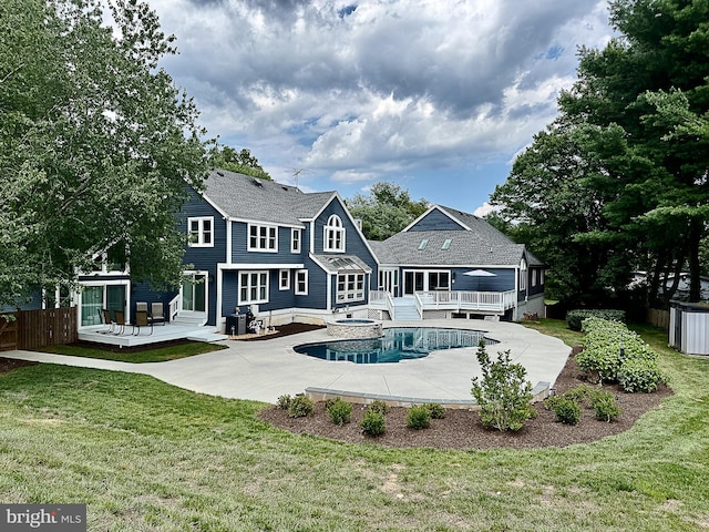 10309 E Hunter Valley Rd, Vienna, VA 22181 - back of property featuring a wooden deck, a patio area, and a pool with connected hot tub