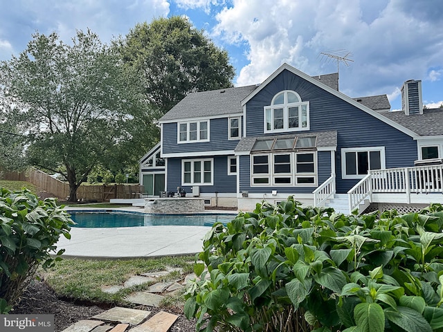 10309 E Hunter Valley Rd, Vienna, VA 22181 - rear view of house featuring an outdoor pool, a wooden deck, a shingled roof, and a patio