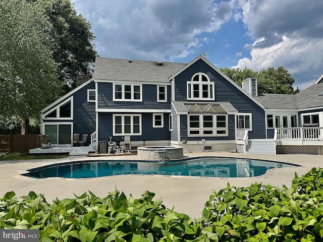 10309 E Hunter Valley Rd, Vienna, VA 22181 - rear view of house with a wooden deck, a patio area, a shingled roof, and a pool with connected hot tub