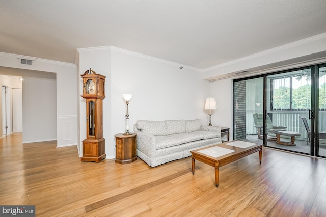15100 Interlachen Dr Unit 4-207, Silver Spring, MD 20906 - living area featuring light wood-style flooring and ornamental molding
