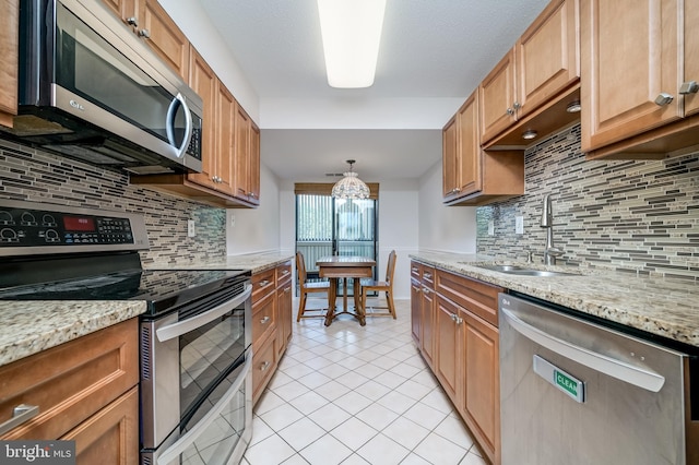 15100 Interlachen Dr Unit 4-207, Silver Spring, MD 20906 - kitchen featuring appliances with stainless steel finishes, tasteful backsplash, light tile patterned floors, and light stone countertops