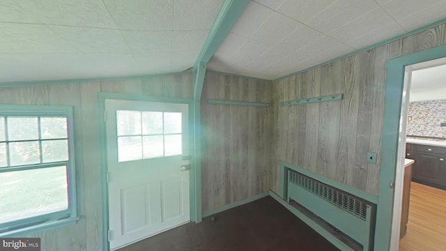 899 Shrivers Corner Rd, Gettysburg, PA 17325 - doorway with radiator, wooden walls, vaulted ceiling, and wood finished floors