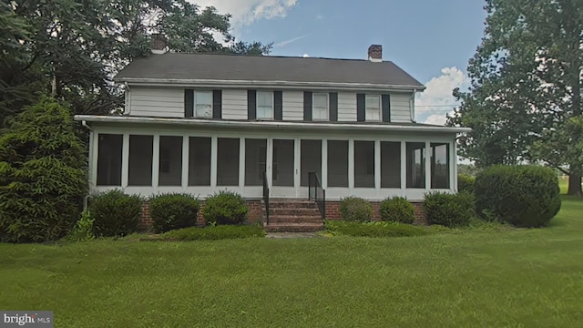899 Shrivers Corner Rd, Gettysburg, PA 17325 - view of front facade with a sunroom, a chimney, and a front yard