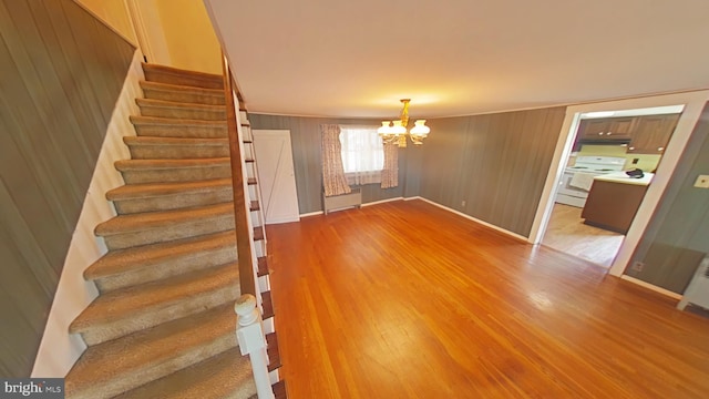 899 Shrivers Corner Rd, Gettysburg, PA 17325 - stairway featuring a chandelier, wood finished floors, and wood walls