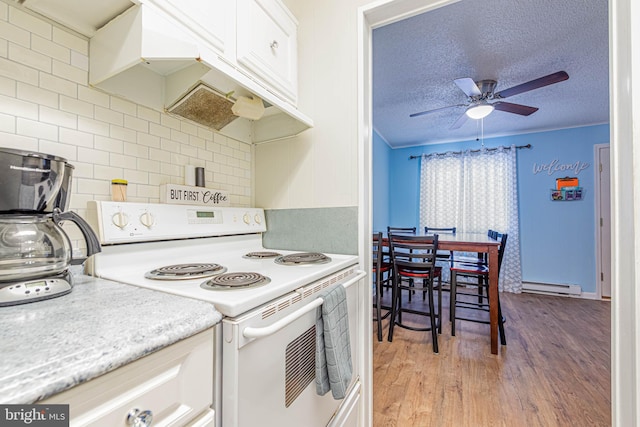 424 Lark Ln Unit E304, Ocean City, MD 21842 - kitchen featuring electric stove, baseboard heating, ceiling fan, light wood-style flooring, and light countertops