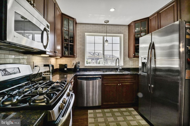4195 S Four Mile Run Dr Unit 203, Arlington, VA 22204 - kitchen with stainless steel appliances, tasteful backsplash, glass insert cabinets, hanging light fixtures, and recessed lighting