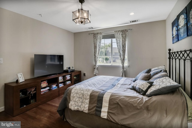 4195 S Four Mile Run Dr Unit 203, Arlington, VA 22204 - bedroom with wood finished floors and a chandelier