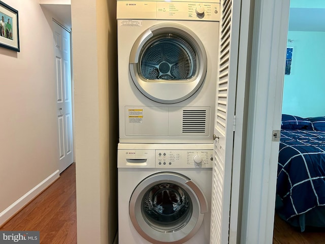4195 S Four Mile Run Dr Unit 203, Arlington, VA 22204 - laundry room with stacked washer / dryer and wood finished floors