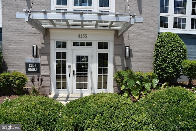 4195 S Four Mile Run Dr Unit 203, Arlington, VA 22204 - view of exterior entry with a pergola, brick siding, and french doors