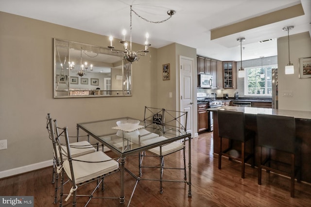 4195 S Four Mile Run Dr Unit 203, Arlington, VA 22204 - dining area with a chandelier and dark wood-type flooring