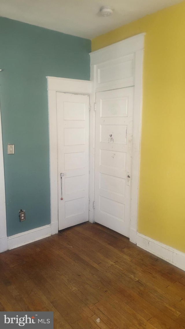 1324 S St SE, Washington, DC 20020 - unfurnished bedroom featuring dark wood-style flooring and baseboards