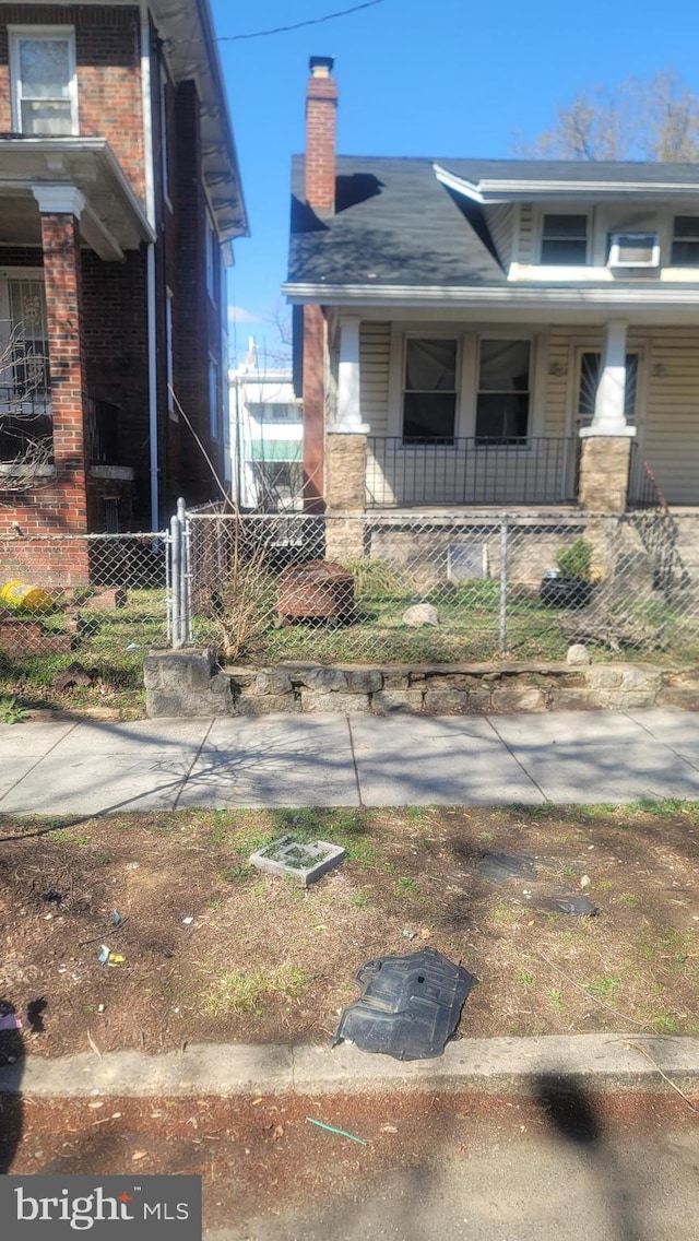 1324 S St SE, Washington, DC 20020 - view of front of property with a porch, a chimney, and brick siding