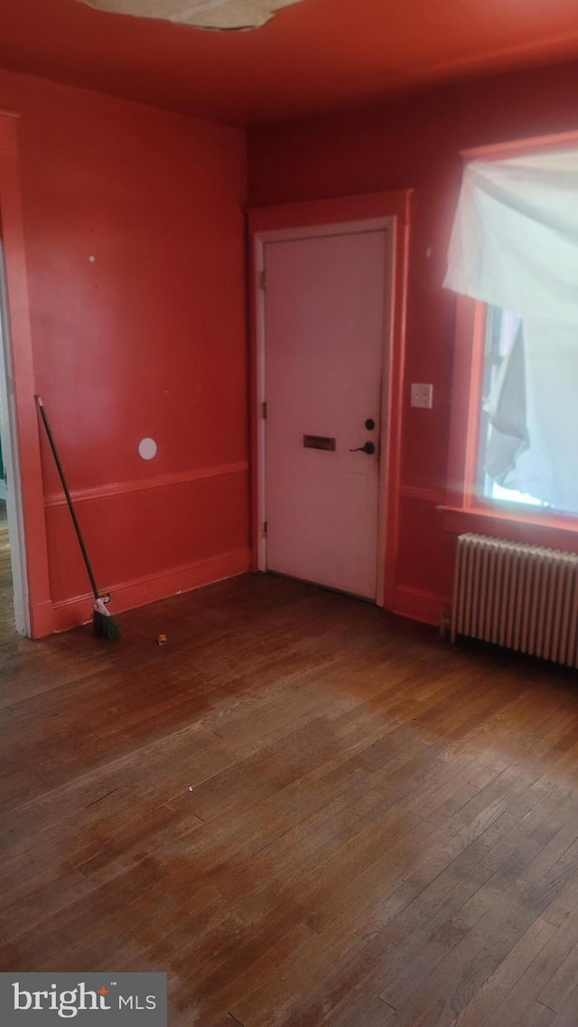 1324 S St SE, Washington, DC 20020 - spare room featuring radiator heating unit and wood-type flooring