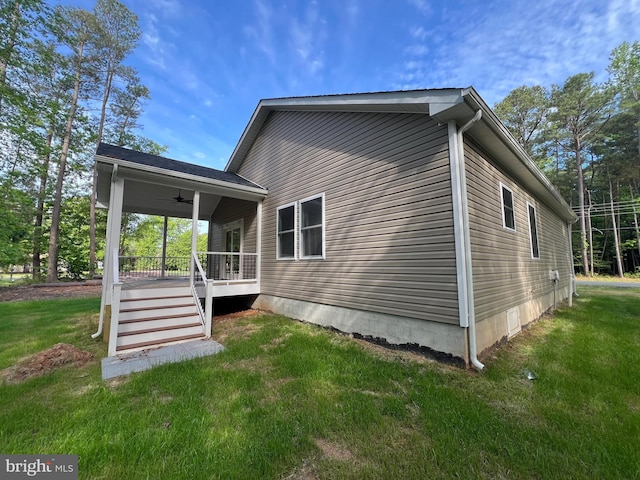 982 Mattox Ave, Colonial Beach, VA 22443 - view of home's exterior with a ceiling fan, a yard, and covered porch