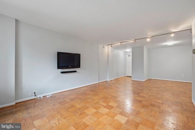 2939 Van Ness St NW Unit 230, Washington, DC 20008 - unfurnished living room featuring baseboards and rail lighting