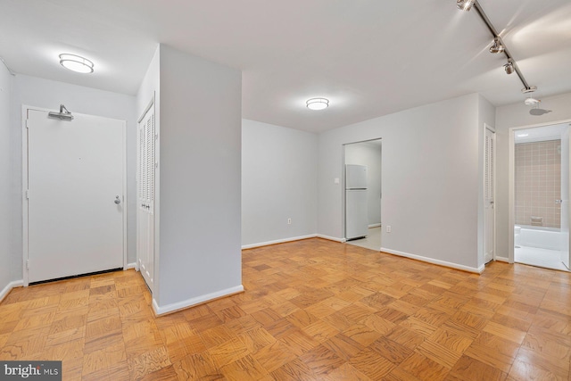 2939 Van Ness St NW Unit 230, Washington, DC 20008 - empty room with baseboards and track lighting