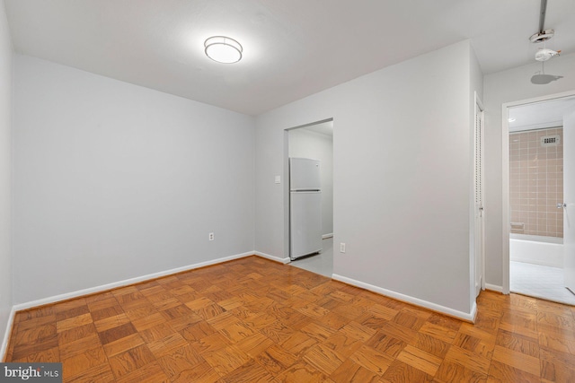 2939 Van Ness St NW Unit 230, Washington, DC 20008 - unfurnished bedroom featuring freestanding refrigerator and baseboards