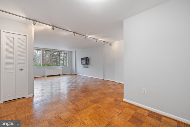 2939 Van Ness St NW Unit 230, Washington, DC 20008 - unfurnished room featuring radiator heating unit and rail lighting