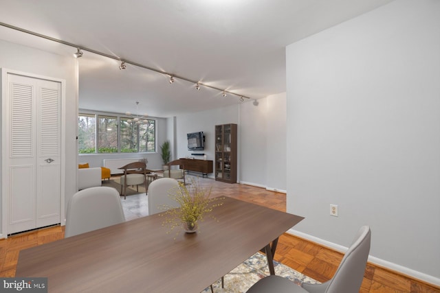 2939 Van Ness St NW Unit 230, Washington, DC 20008 - dining room with rail lighting and baseboards