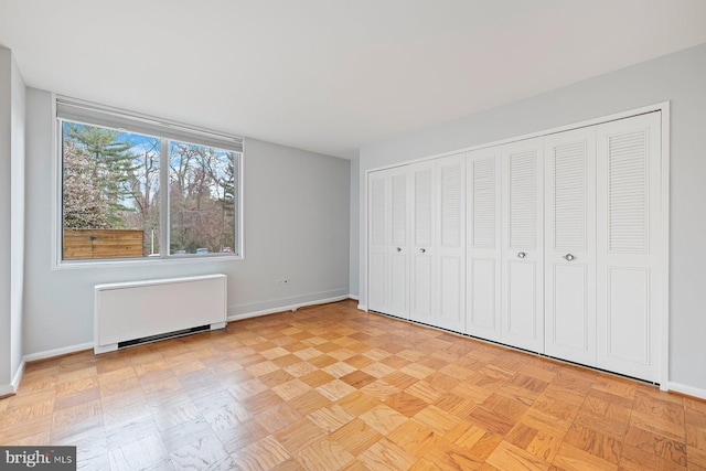 2939 Van Ness St NW Unit 230, Washington, DC 20008 - unfurnished bedroom with radiator and baseboards