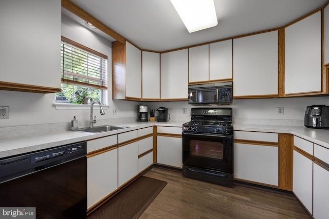 1501 Wheaton Ln, Silver Spring, MD 20902 - kitchen with black appliances, light countertops, dark wood finished floors, and white cabinetry