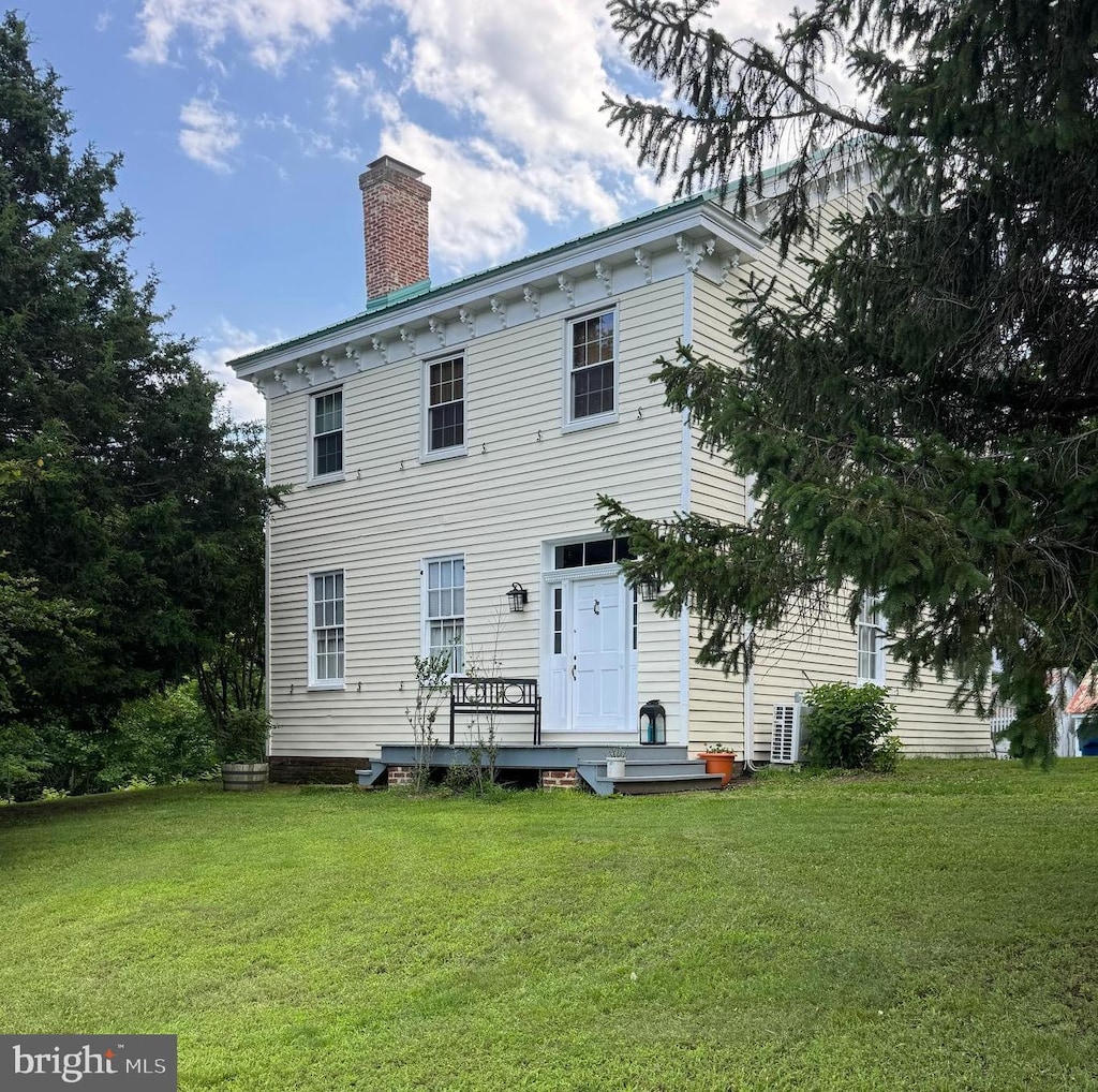 10007 Croom Rd, Upper Marlboro, MD 20772 - view of front of home featuring a chimney, a front yard, and a wooden deck