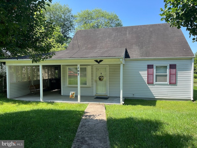 107 Forrest St, Manassas Park, VA 20111 - view of front of home with a front lawn, roof with shingles, and covered porch