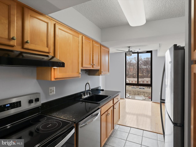 4500 S Four Mile Run Dr Unit 927, Arlington, VA 22204 - kitchen with stainless steel appliances, ventilation hood, a textured ceiling, and light tile patterned floors