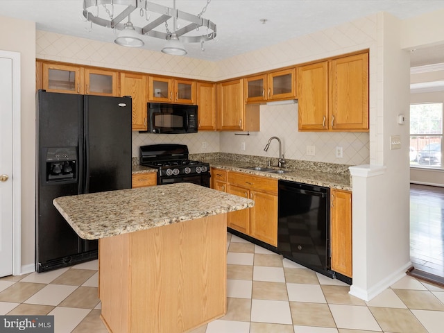 8730 Thornbrook Dr, Odenton, MD 21113 - kitchen featuring black appliances, a kitchen island, tasteful backsplash, and light stone countertops