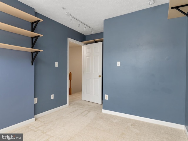 8730 Thornbrook Dr, Odenton, MD 21113 - unfurnished bedroom with carpet and rail lighting