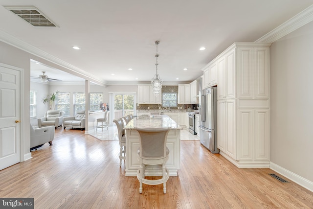 8 Ashley Ct, Stafford, VA 22554 - kitchen featuring high end appliances, light stone countertops, open floor plan, a kitchen island, and a breakfast bar