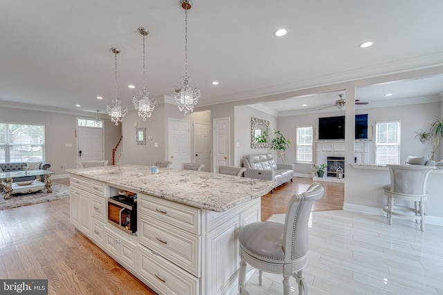 8 Ashley Ct, Stafford, VA 22554 - kitchen with a kitchen bar, recessed lighting, plenty of natural light, ornamental molding, and stainless steel microwave