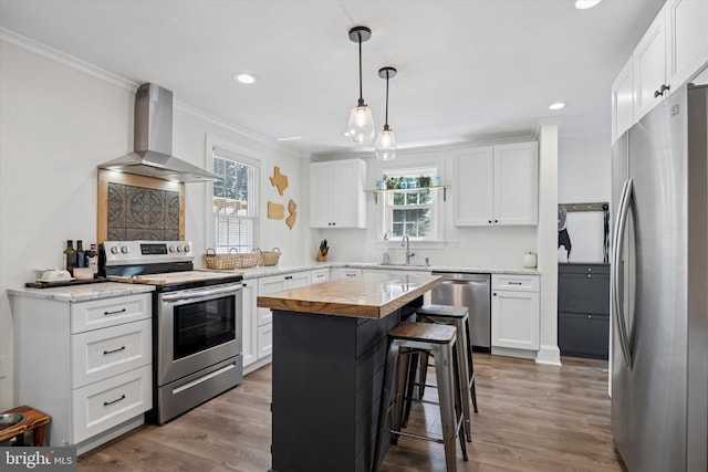 927 Drexel Ave, Drexel Hill, PA 19026 - kitchen featuring stainless steel appliances, wall chimney range hood, crown molding, butcher block counters, and dark wood finished floors